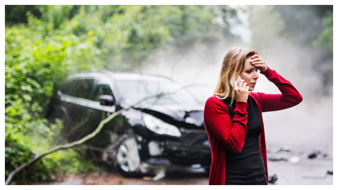 A woman on the phone after a car accident in Tampa Bay.
