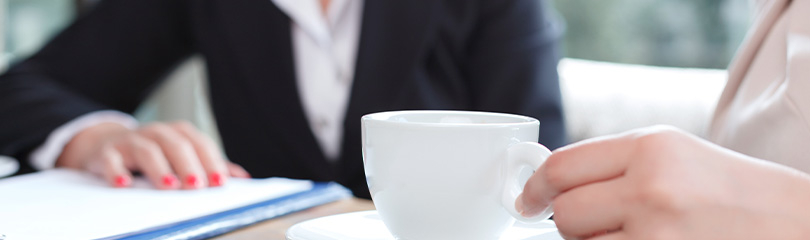 lawyer meeting with their client over coffee