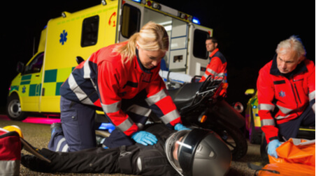 Paramedics attending to an injured man after a motorcycle accident in Florida.