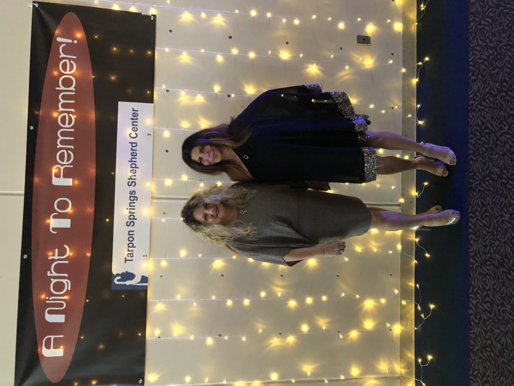 Lauren Calta and Angela Zervos posing in front of A Night to Remember banner