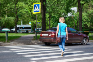 A woman walking across a pedestrian crossing in Spring Hill FL.