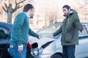 Two drivers arguing on the car accident.