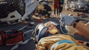 car crash victim on a backboard with head brace