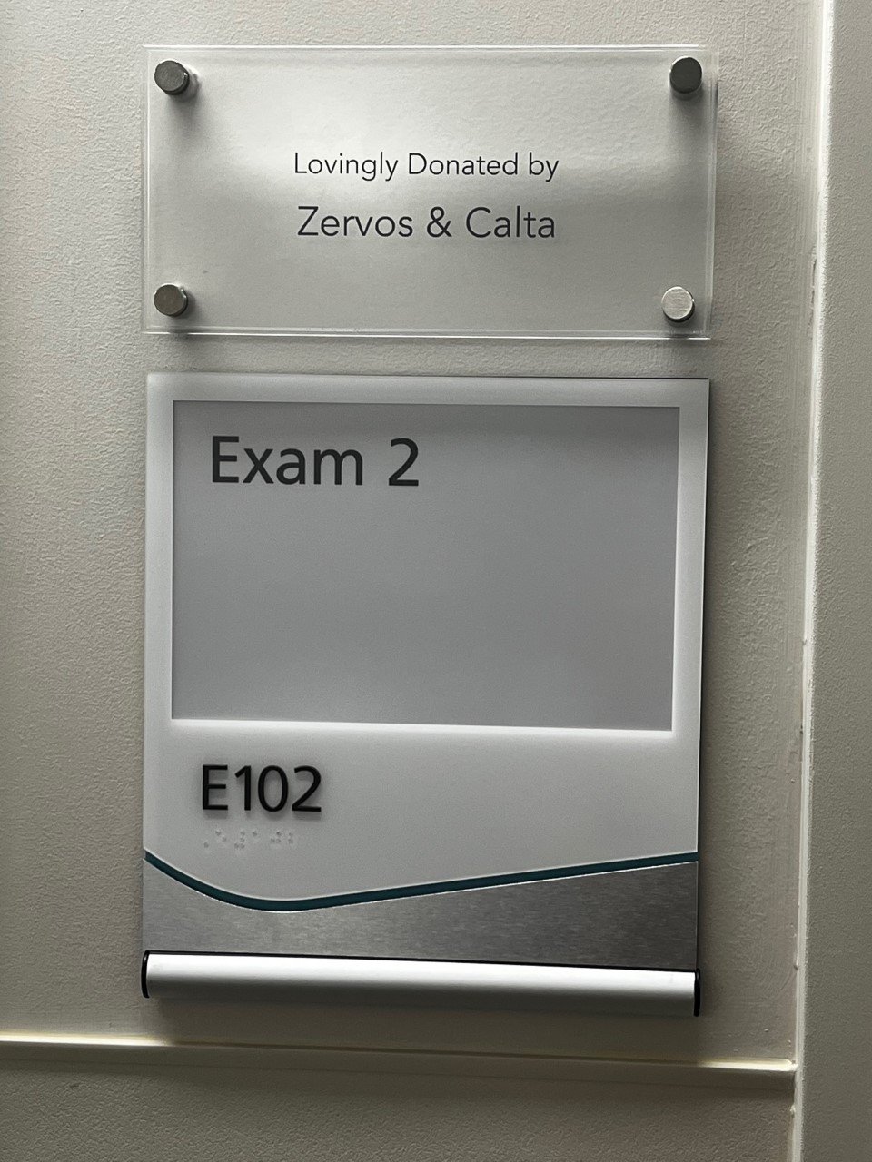 Plaque on exam room door showing it was donated by Zervos and Calta