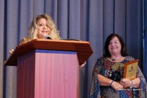 Lauren Calta of Zervos & Calta giving speech after accepting award for their participation in Wheelchairs 4 Kids