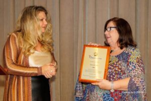 Lauren Calta of Zervos & Calta accepting award for their participation in Wheelchairs 4 Kids