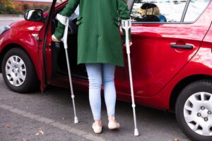 Woman on crutches due to car accident.