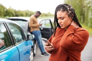 Female driver feeling pain in the neck after car accident.