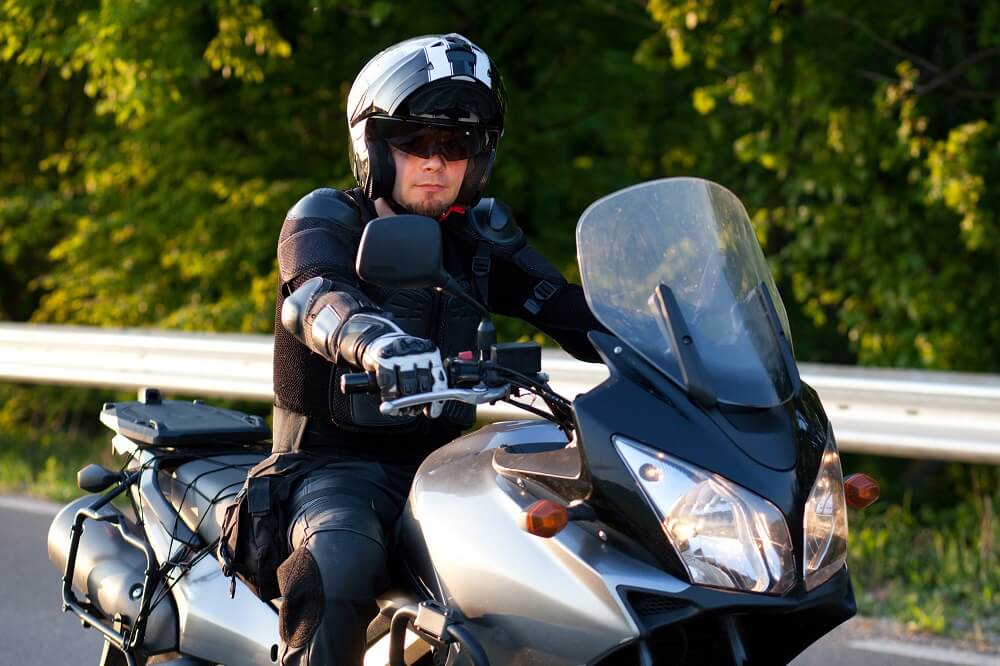 Motorcycle rider wearing safety gear.