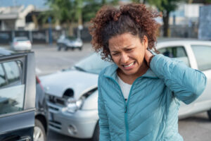 Female driver feeling pain from whiplash accident.