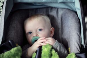 child in a safety seat in a car