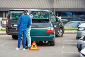 Drivers discussing accident fault in the parking lot.