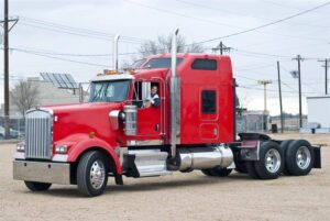 Red semi-truck bobtail parking.