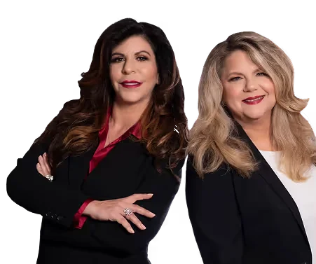 Two professional women with long hair, wearing black blazers, smiling against a transparent background.