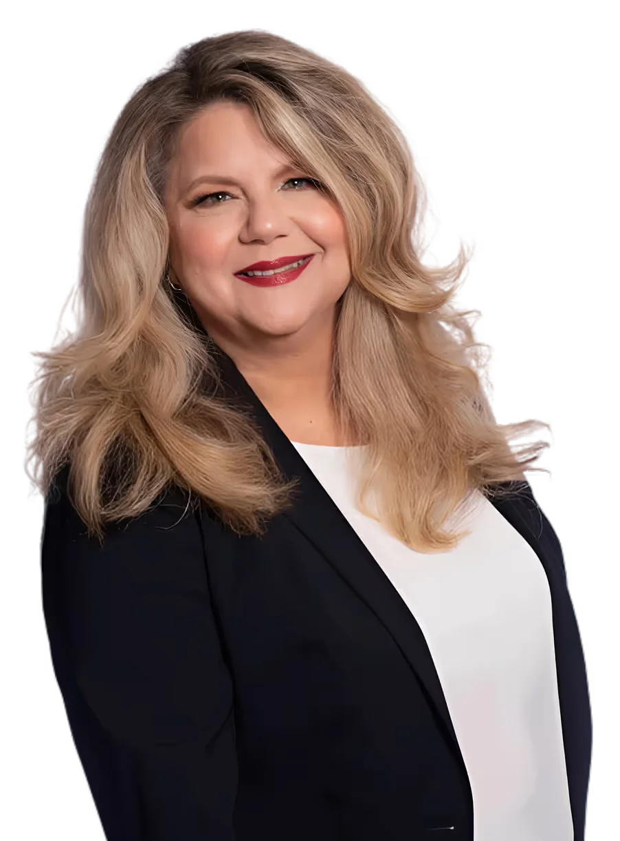 Smiling woman with long wavy blonde hair wearing a black blazer and white top.